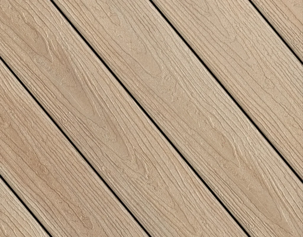 Close-up of Fiberon Concordia decking in Prairie Wheat, a warm beige tone with natural wood-grain texture. The surface features soft golden hues that add warmth and character, ideal for cozy outdoor spaces.