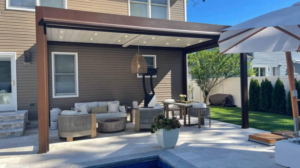 Modern aluminum pergola with LED lighting and comfortable patio furniture near pool.