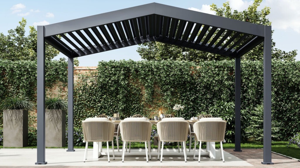 Modern aluminum pergola over outdoor dining table with light chairs surrounded by greenery.