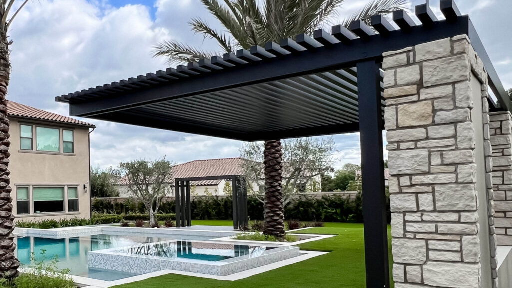 Modern black pergola with stone columns and poolside seating in contemporary backyard.