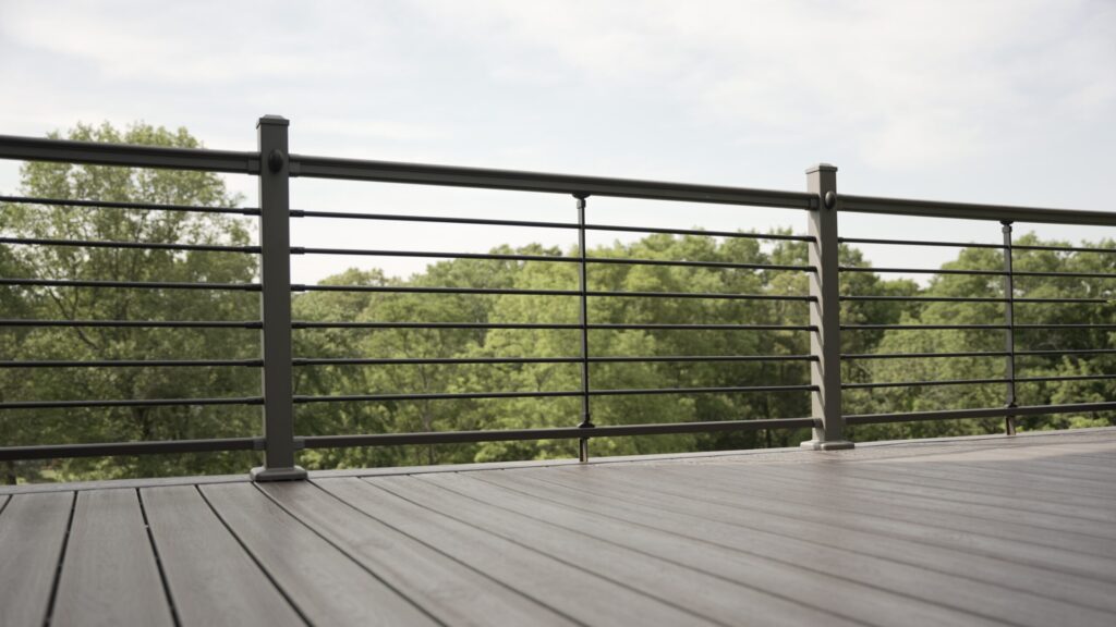 Gray aluminum horizontal deck railing with composite decking and minimalist modern design.