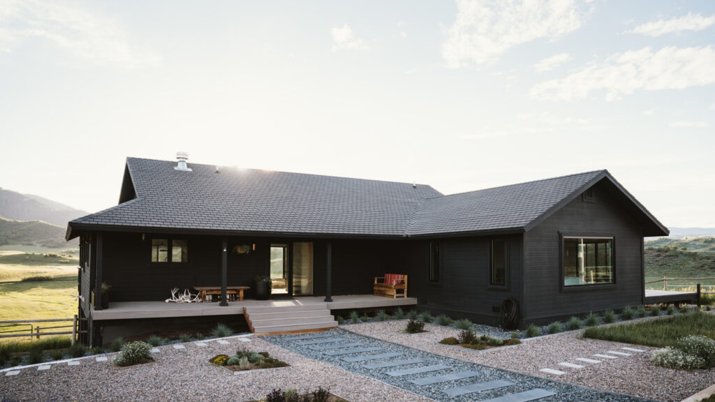 TimberTech Coastline front entry deck on dark ranch-style home with mountain views.