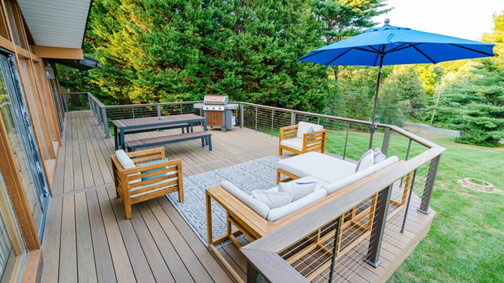 TimberTech composite deck with keylink stainless cable railing and outdoor seating, modern cable railing ideas for deck inspiration.