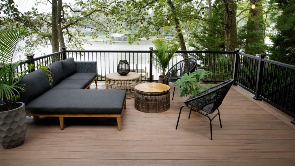 TimberTech Vintage English Walnut deck overlooking river with cozy outdoor seating.
