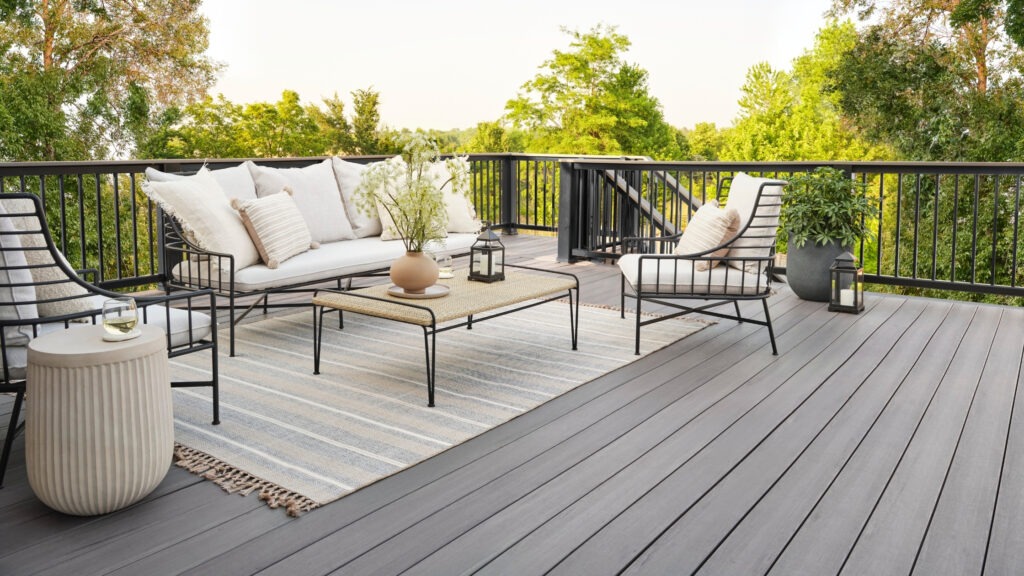 TimberTech Landmark Castlegate deck with modern black rail and neutral outdoor furniture.