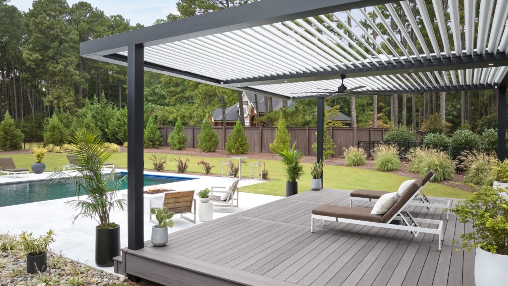 TimberTech Castle Gate Landmark deck with StruXure pergola and poolside seating area.