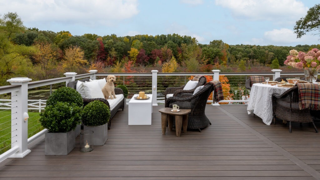 TimberTech Legacy Mocha deck with outdoor dining area and natural wood-grain pattern.