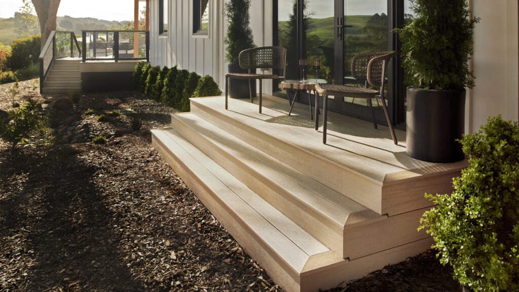 TimberTech Reclaimed Chestnut hillside deck with cable railing and scenic mountain view.