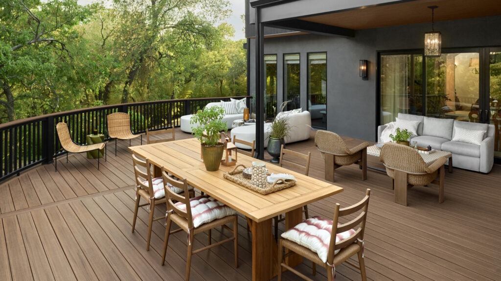 TimberTech Vintage English Walnut outdoor dining deck with black railing and modern furniture.