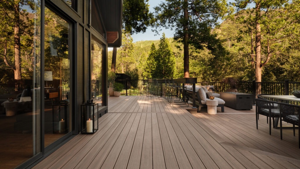TimberTech English Walnut deck with glass doors and modern patio furniture.