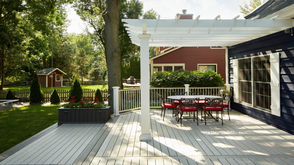 TimberTech AZEK Whitewash Cedar deck with Kona drink rail and outdoor dining area.