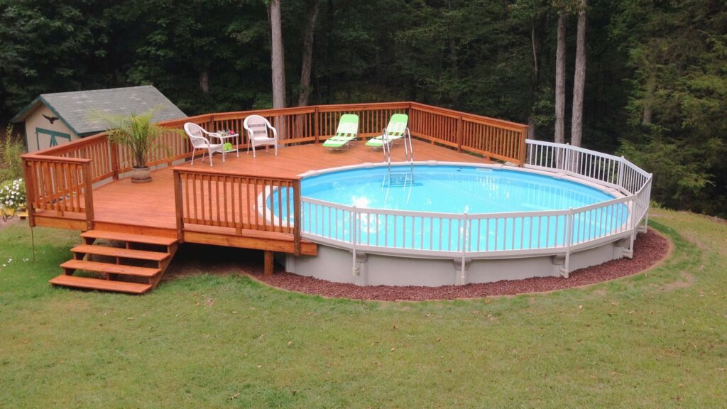 Wooden pool deck with orange-tone railings and natural green setting.