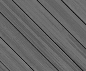 Circular swatch of Envision Distinction Grey Wood composite decking showing cool gray tones with subtle wood grain variation. The surface features natural-looking streaks and a soft, weathered appearance that pairs well with modern and coastal deck designs.