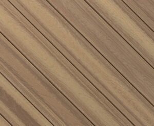 Circular swatch of Envision Distinction Rockaway Beach composite decking displaying blended tan and light brown tones with subtle grain movement. This Cool Thread® color delivers a sun-washed wood appearance with improved underfoot comfort.