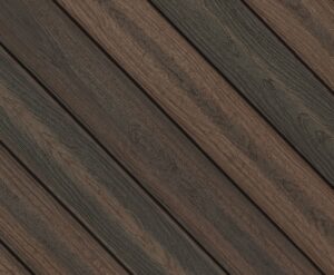 Circular swatch of Envision Distinction Rustic Walnut composite decking highlighting deep brown tones with darker accents and pronounced wood grain. The rich color variation creates a bold, exotic hardwood-inspired look.