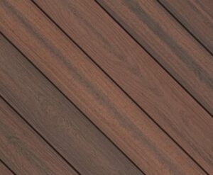 Circular swatch of Envision Distinction Shaded Auburn composite decking showing warm reddish-brown tones with darker grain highlights. The color variation adds depth and character inspired by natural hardwood planks.