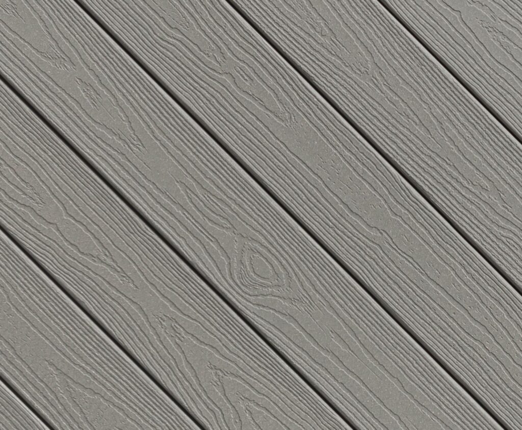 Close-up view of Envision EverGrain composite decking in Cape Cod Grey, showing a cool-toned gray color with deep, non-repeating woodgrain texture. The boards feature a matte finish that mimics weathered natural wood while maintaining a uniform, low-maintenance surface.
