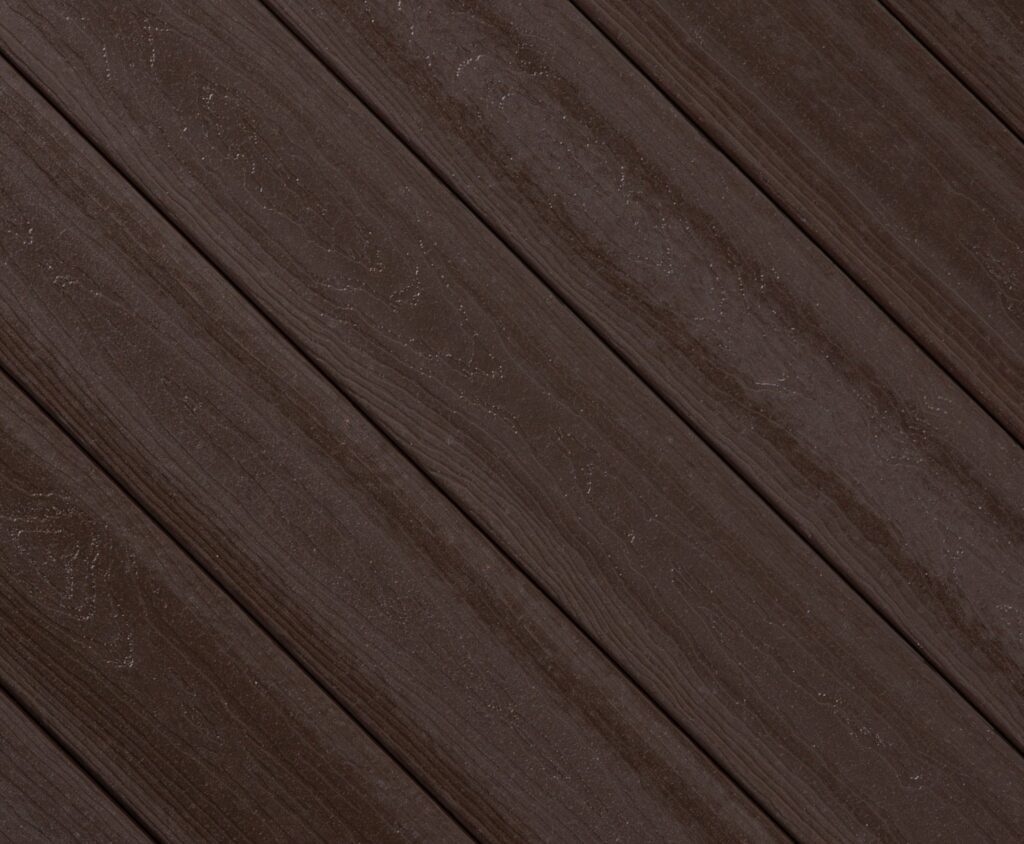 Close-up swatch of Envision Ridge Premium Gunstock composite decking displaying warm medium-brown hues with natural woodgrain texture and classic character.