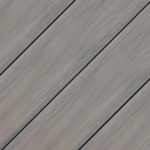 Close-up of Wolf Haven Storm cellular PVC deck boards showing layered gray tones, soft weathered grain texture, and smooth matte finish inspired by aged coastal wood.