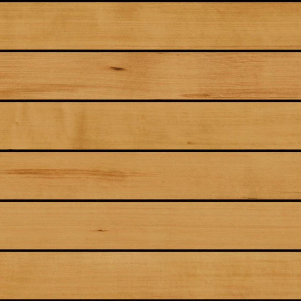 Fiberon Novus Golden Cedar composite decking board featuring warm honey-gold tones with subtle cedar woodgrain detailing and a smooth, natural hardwood-inspired finish.