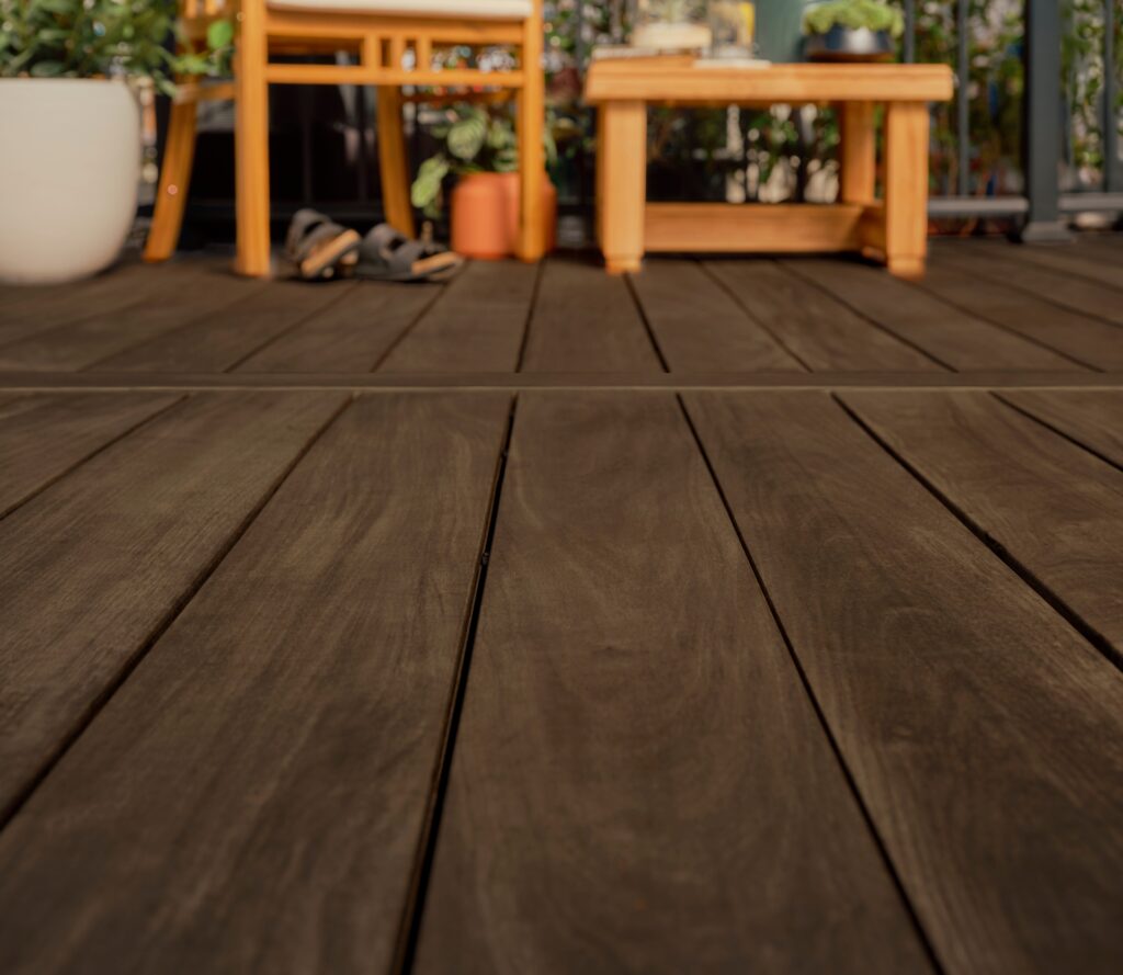 Close-up view of Fiberon Novus Natural Ipe decking highlighting realistic, non-repeating hardwood grain patterns. The rich brown finish and subtle surface texture deliver the look of exotic ipe with a smooth, low-sheen appearance.