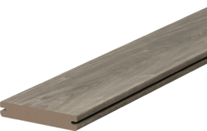 Fiberon Novus Weathered Ipe grooved-edge composite decking board displayed in a product close-up. The board features soft gray-brown tones with subtle weathered woodgrain texture and precision side grooves for hidden fastener installation.