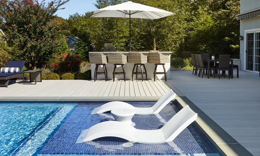 Stacked composite decking boards displaying multiple color options and textured finishes. The capped composite decking design shows why applying paint or stain can lead to poor adhesion and uneven results.