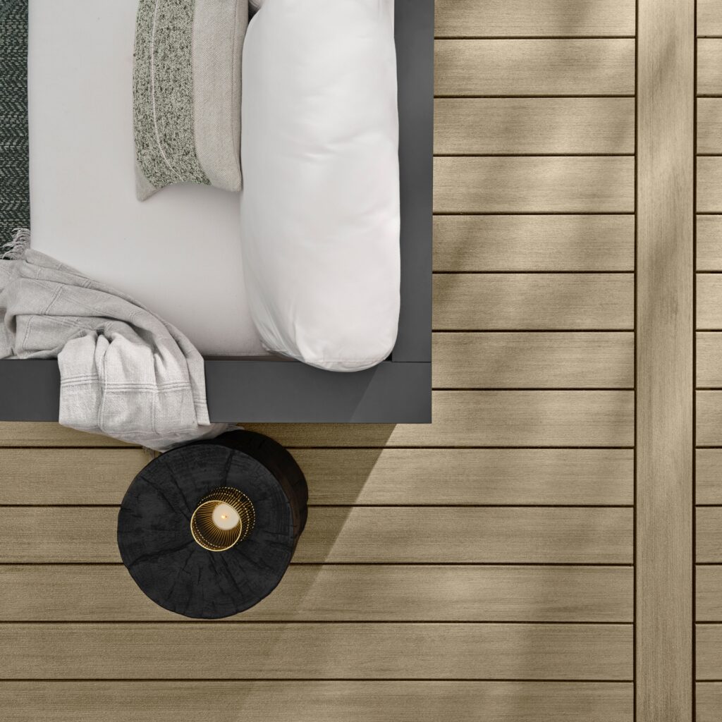 Close-up of TimberTech Premier+ Natural Oak composite decking boards showing straight-grain wood texture, subtle color variation, and low-maintenance polymer-capped finish.