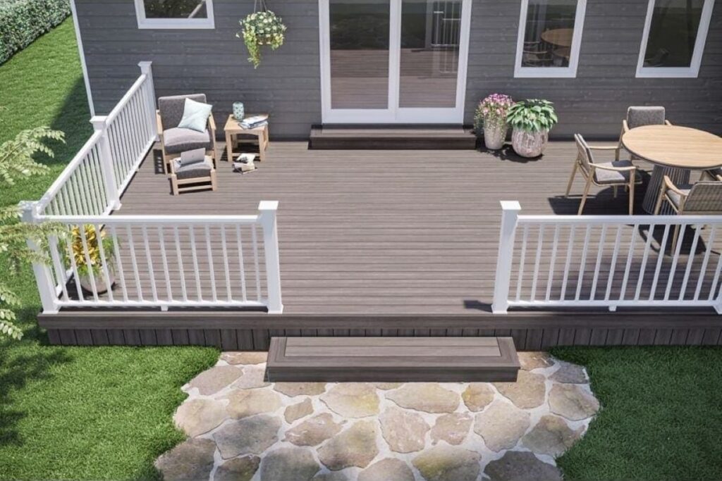 Deckorators Pioneer Lakeview Grey decking on an elevated deck with white railing and patio furniture, highlighting the soft grey color and modern outdoor design.