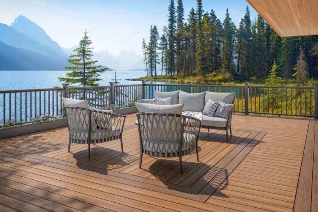 Outdoor deck built with Timberline Brown boards, paired with modern furniture and surrounded by a scenic lake and mountain view.