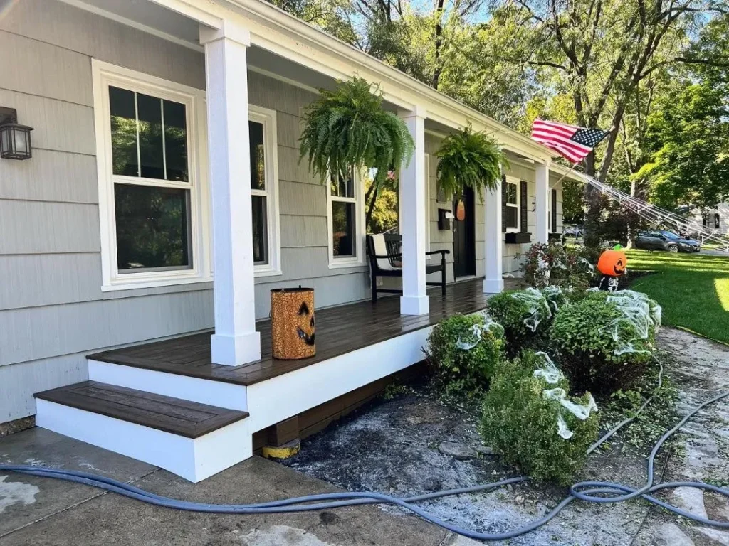 Front porch composite decking with white columns built by Griffith Decking serving Plainfield IL and Will County.