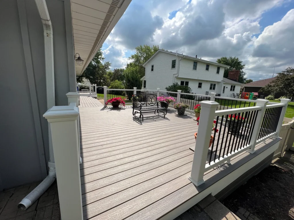Composite deck with white railing and outdoor seating area built by Griffith Decking serving Plainfield IL homeowners.