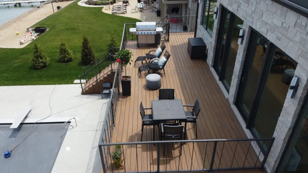 Multi-level composite deck with stairs and poolside lounging area built by Mitchell Construction Custom Decks serving Plainfield IL and the Chicago suburbs.