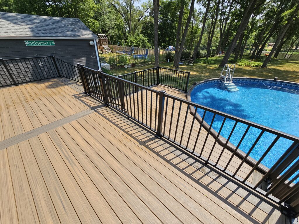 Poolside composite deck with black railing built by Partipilo Custom Decks serving Plainfield IL and surrounding Will County.
