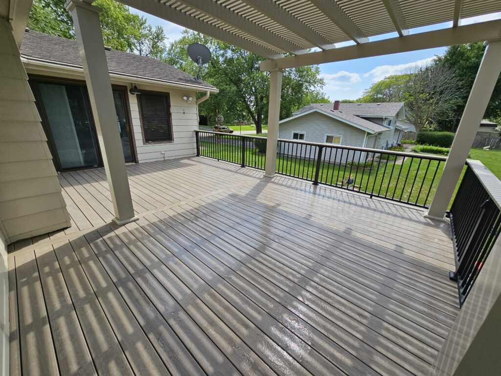 Covered composite deck with pergola and railing installed by Partipilo Custom Decks deck builder near Plainfield Illinois.