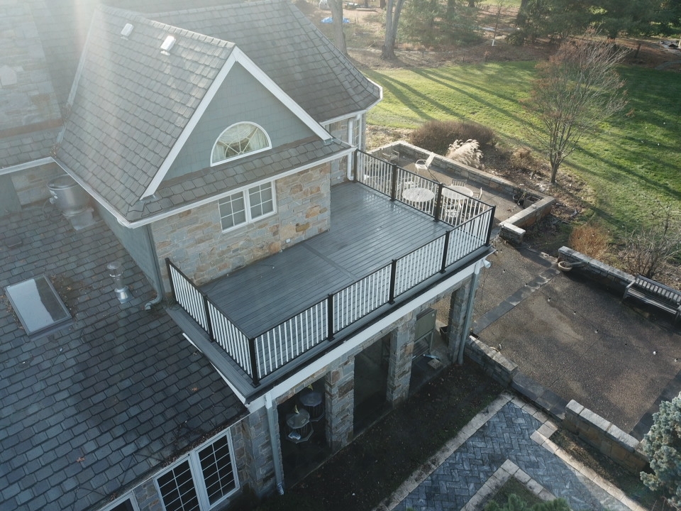 Elevated composite deck with black aluminum railing built by Partipilo Custom Decks serving Plainfield IL homeowners.