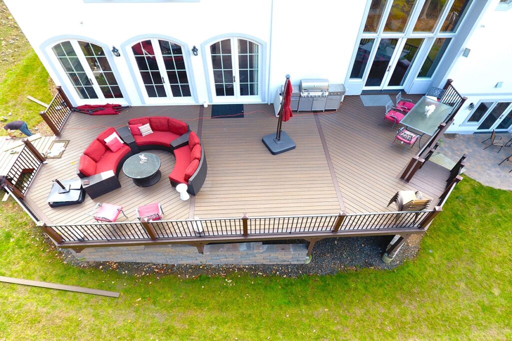 Composite deck with white railing and outdoor dining space installed by Royal Deck deck builder near Plainfield Illinois.