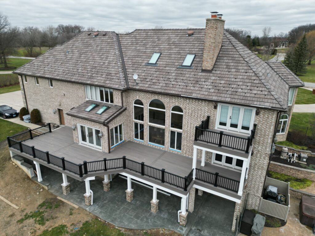 Large multi-level composite deck with black aluminum railing built by Warner’s Decking serving Plainfield IL and the Chicagoland area