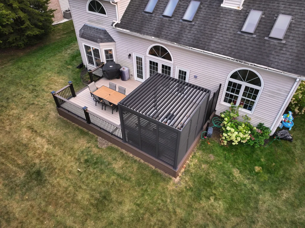 Elevated composite deck with pergola shade structure and outdoor seating area built by Wolf Spirit Deck serving Plainfield IL homeowners.