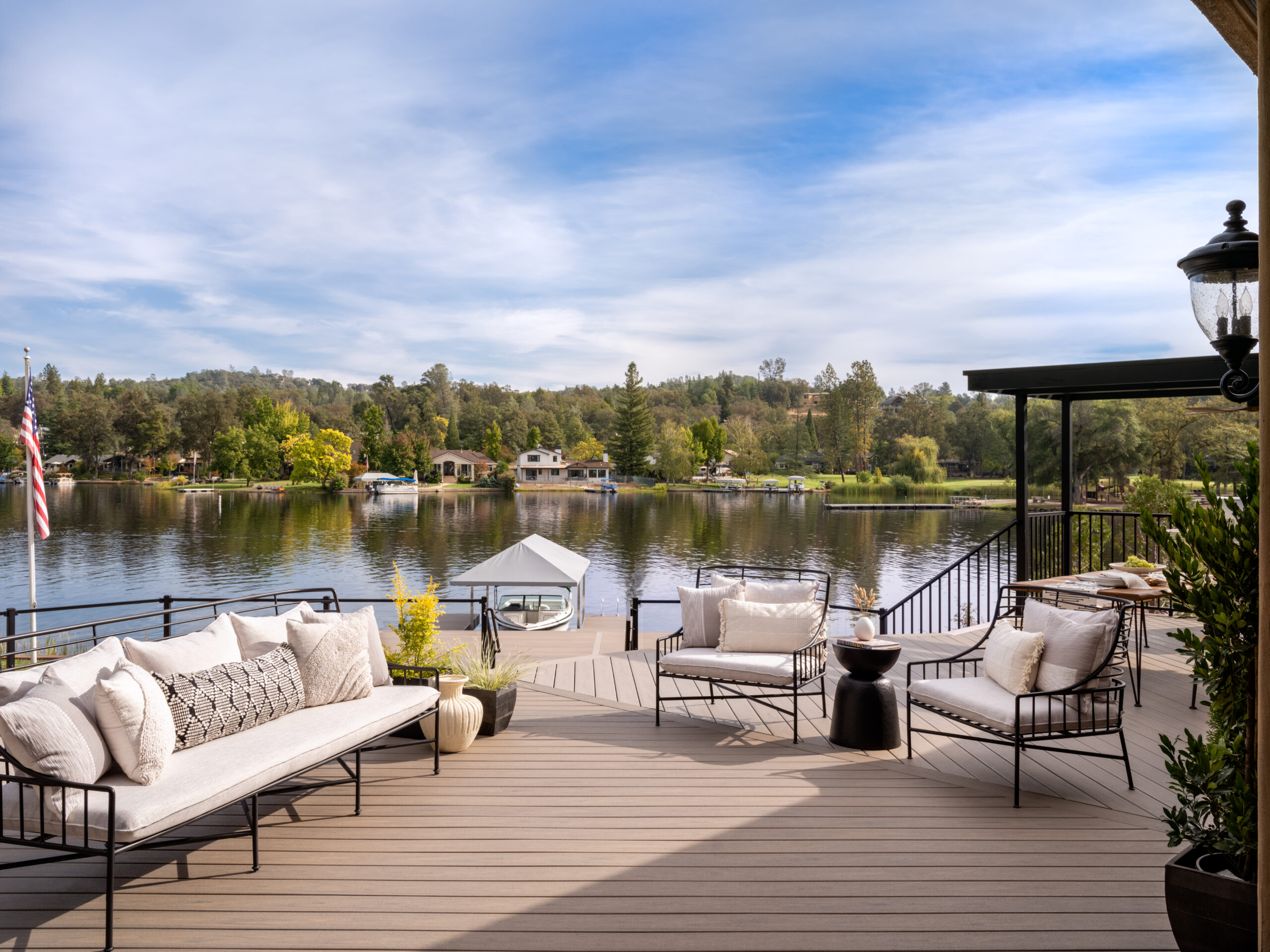 Trex vs Lumberock decking comparison showing a modern composite deck overlooking a lake with outdoor seating