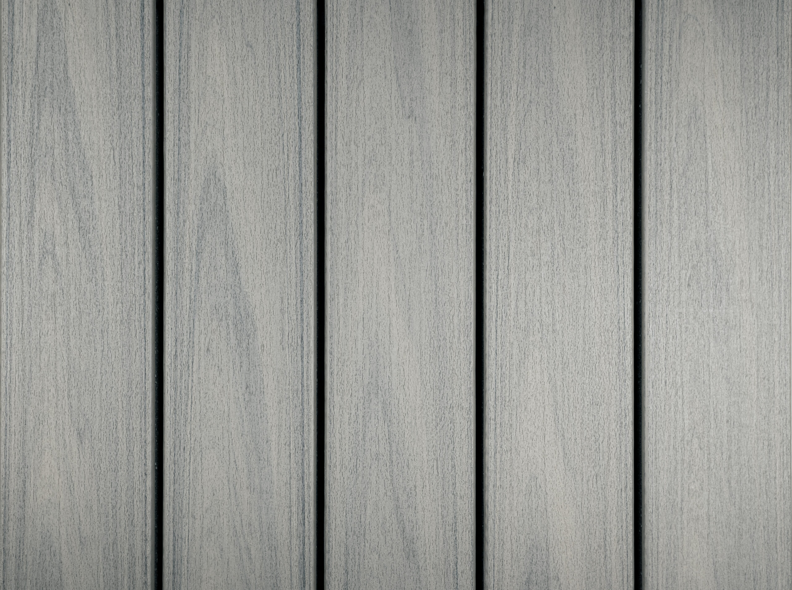 Trex Transcend Lineage composite decking boards in Rainier color with a light gray wood grain texture. This lighter deck color helps reflect sunlight and works well for decks built in full sun.