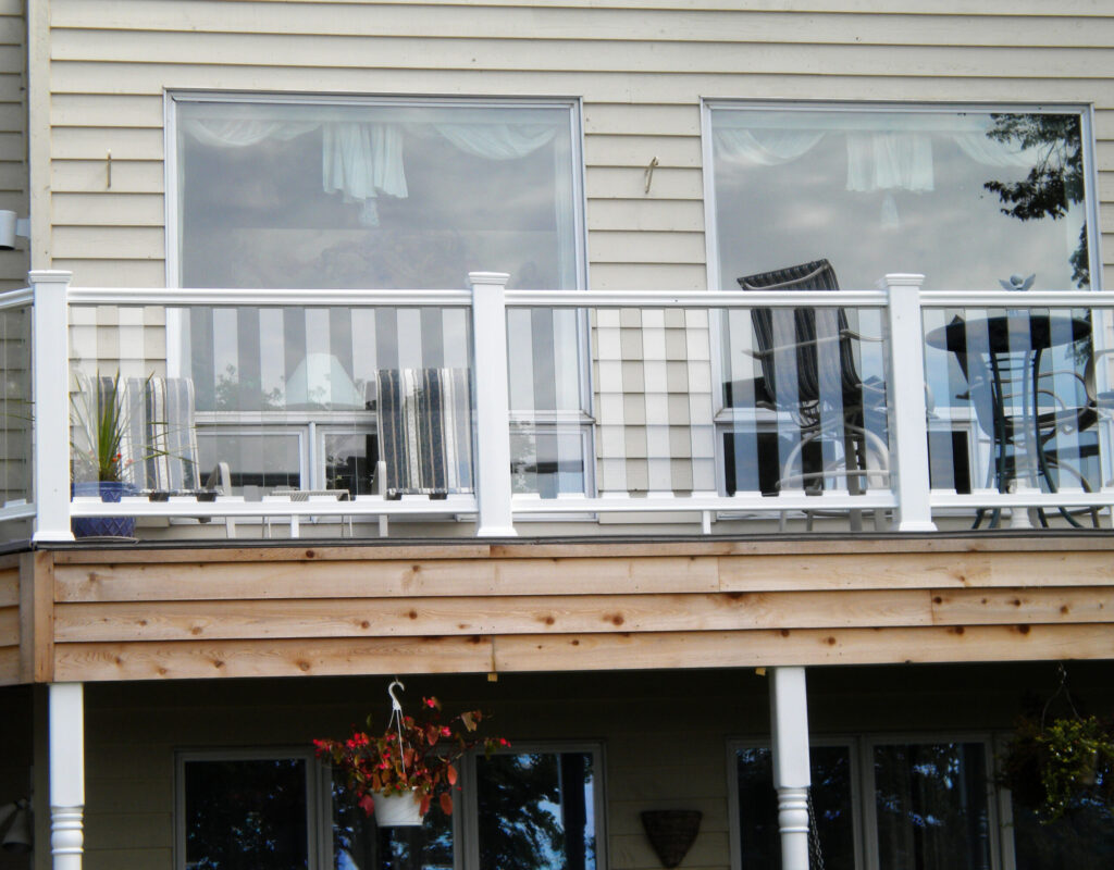 Envision Designer composite deck railing in white with glass panel infill, combining durability and unobstructed views for a clean, modern outdoor design.