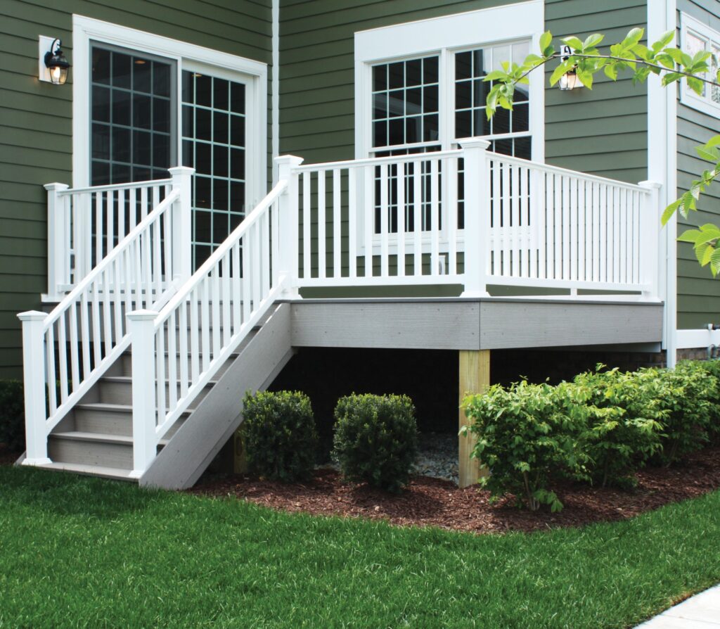 Envision Traditional vinyl deck railing in white with vertical balusters, providing a clean, durable, and low-maintenance railing system for outdoor decks.