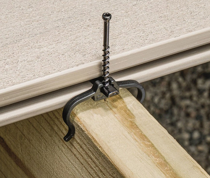 Installing Fiberon EDGE hidden fastener clip into grooved deck board with drill