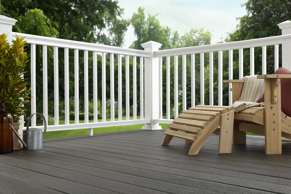 White composite railing surrounding a deck with outdoor seating, creating a clean and low-maintenance space for homes in the Chicago suburbs.