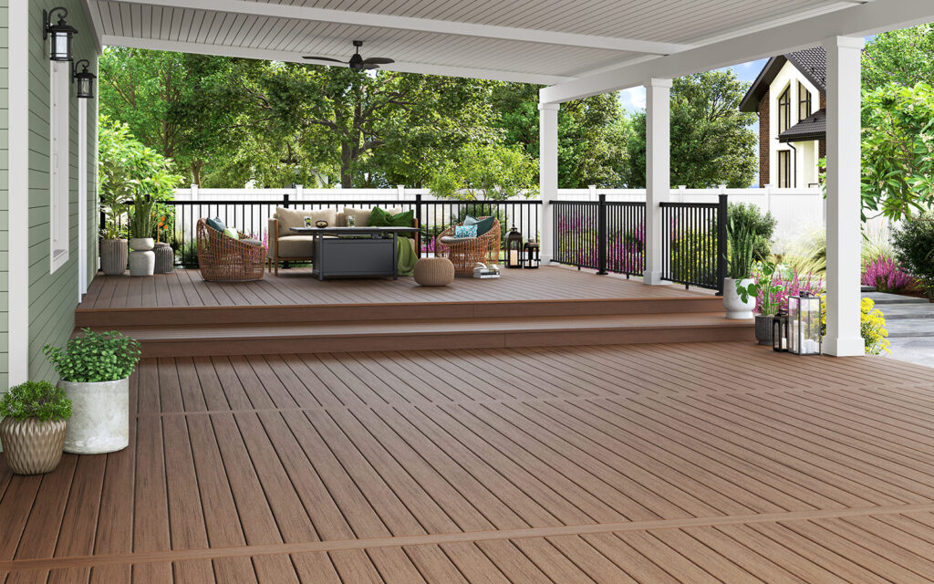 MoistureShield Stratos Athena decking installed on a spacious covered backyard deck with warm brown composite enhanced PVC boards, modern black railing, and outdoor seating area designed for durability and comfort.