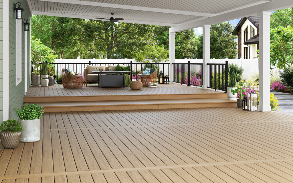 MoistureShield Stratos Mykonos decking featured on a large covered backyard deck with light beige composite enhanced PVC boards, black railing, and modern outdoor seating area.
