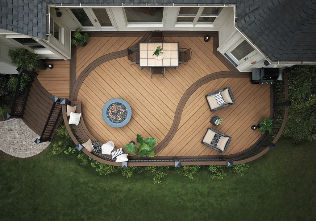 TimberTech decking backyard patio with built-in fireplace and seating area, designed for durable outdoor living spaces in Downers Grove.