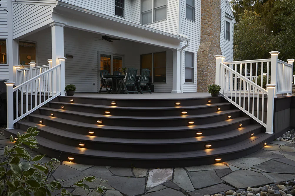 Close-up of composite timbertech deck steps with recessed LED lighting, highlighting durable and low-voltage lighting solutions for Midwest outdoor decks.