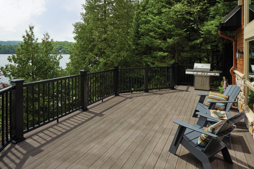 TimberTech Premier Rail composite deck railing with black posts, black rails, and black balusters on large lakeview deck.